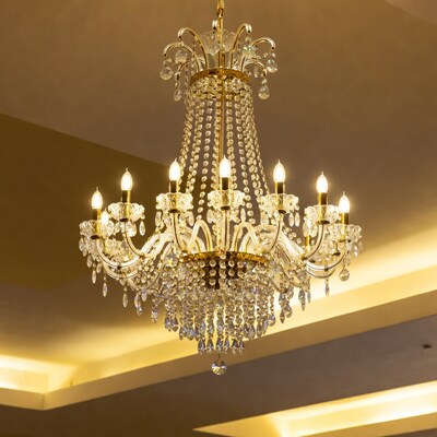 Golden crystal chandelier with lit candles