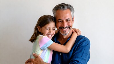 Father hugging smiling daughter