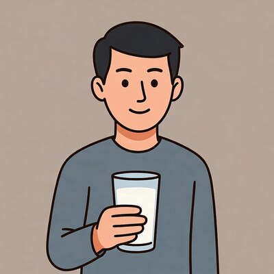 Asian man holding glass of milk