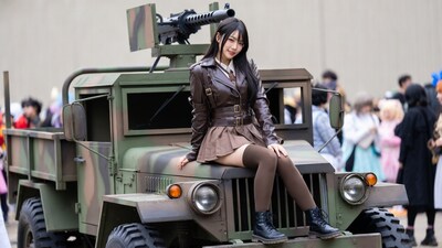 Asian woman in cosplay on military truck
