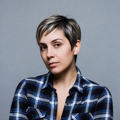 Woman with short blonde hair in plaid shirt