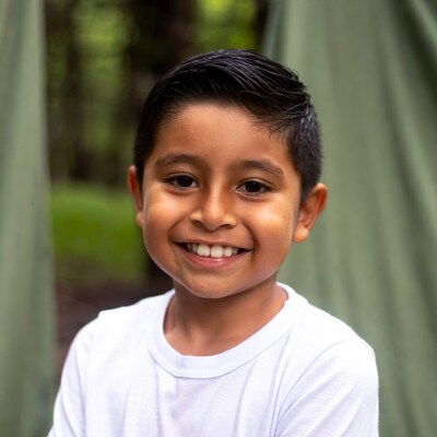 Smiling Latino boy in forest