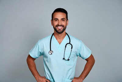 Smiling male doctor in scrubs