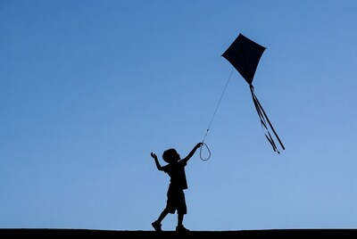 Boy flying kite silhouette