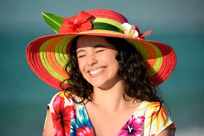 Woman smiling in colorful hibiscus hat