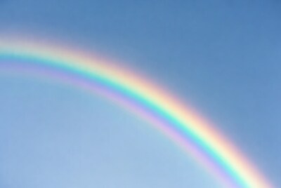 Vibrant Rainbow in Blue Sky