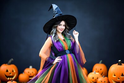 Woman in witch costume with pumpkins