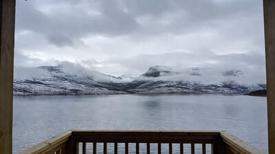 Snowy mountains over lake from deck