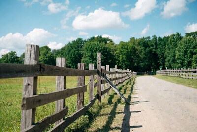 Rustic wooden fence along dirt road