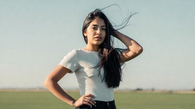 Latina woman with flowing hair in field