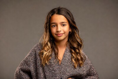 Smiling girl in gray sweater