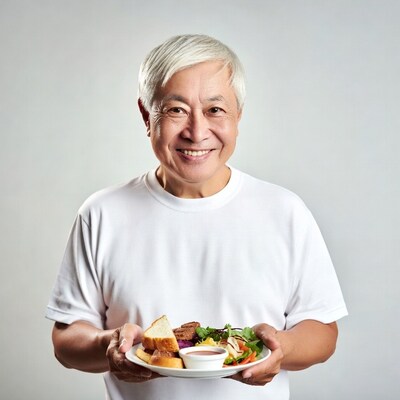 Elderly Asian man holding plate of food