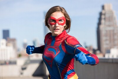 Woman in Supergirl costume on rooftop