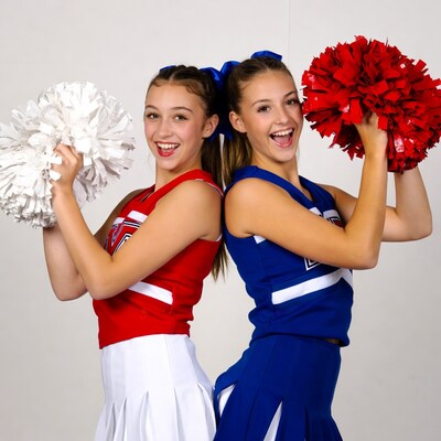Two cheerful cheerleaders with pom poms