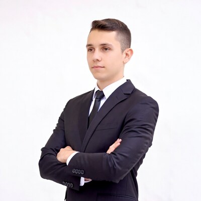 Young man in suit arms crossed