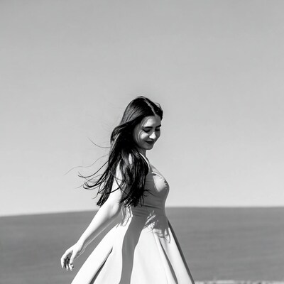 Woman in flowing dress by sea