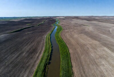 Aerial view of meandering river in farmland