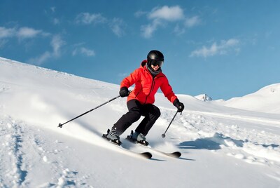 Woman skiing down snowy mountain