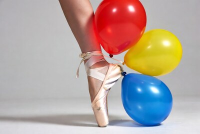 Ballerina pointe shoe on colorful balloons