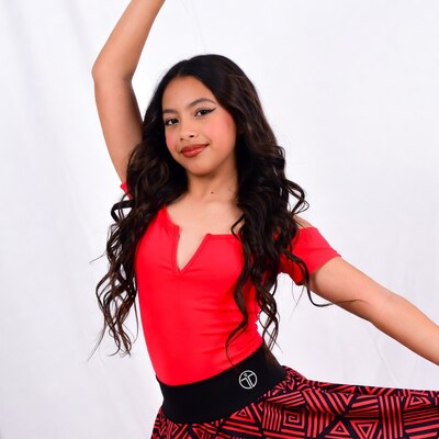 Young Latina girl dancing in red outfit