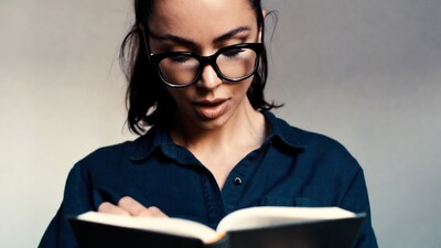 Woman reading book in glasses