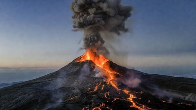 Erupting volcano with lava flows