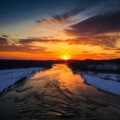 Sunset over snowy river