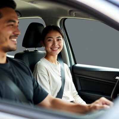 Asian couple smiling in car