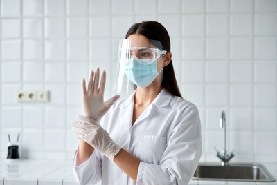 Female doctor putting on gloves