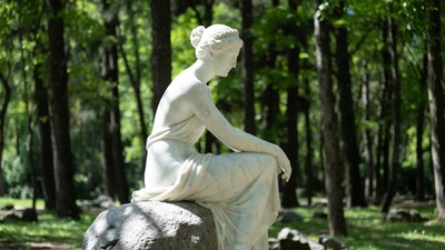 White marble woman statue on rock