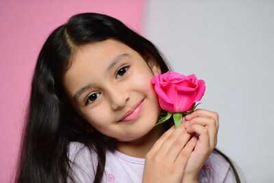 Girl holding pink rose