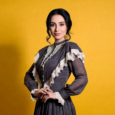 Woman in lace Victorian dress on yellow background