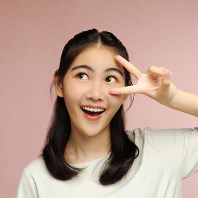Asian girl peace sign pink background