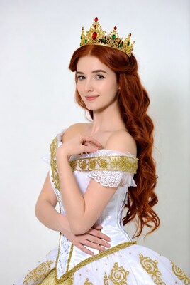 Redhead woman in gold crown and white gown