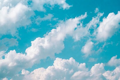 Fluffy white clouds in blue sky