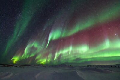 Vibrant Northern Lights over Snowy Landscape