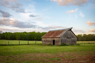 Rustic red barn in green pasture