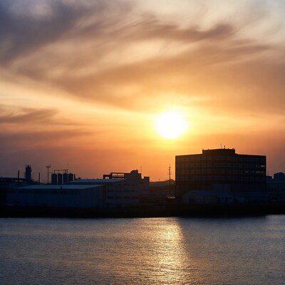 Industrial Silhouette at Sunset over River