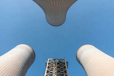 Two Cooling Towers Against Blue Sky