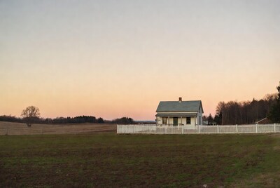White farmhouse at sunset