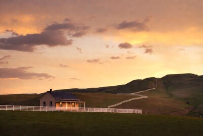 Country house at sunset with hills