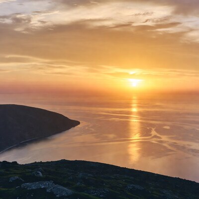 Sunset over sea and coastal cliffs