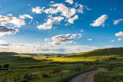 Green rolling hills with dirt path