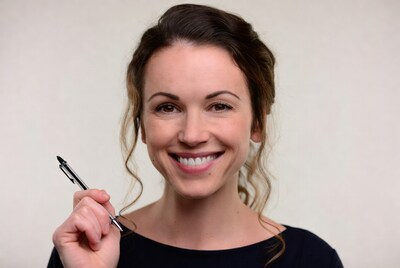 Smiling woman holding pen