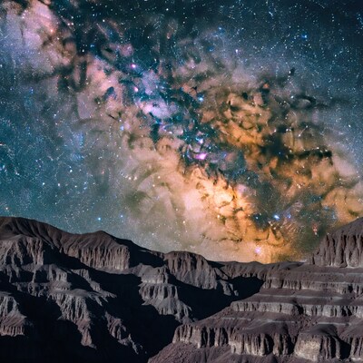 Milky Way over layered badlands