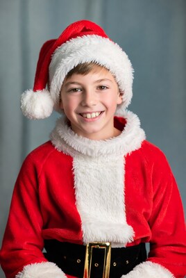 Boy smiling in Santa Claus costume