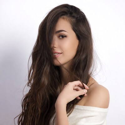Woman with long wavy brown hair smiling