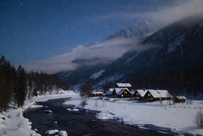 Snowy Chalet Village Under Starry Mountains