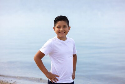 Smiling Latino boy on beach