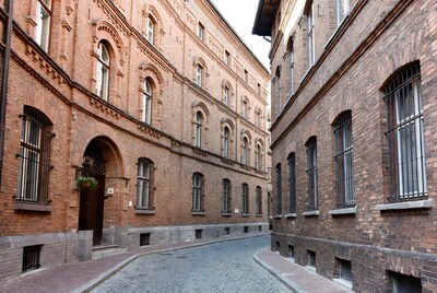 Narrow cobblestone alley between brick buildings